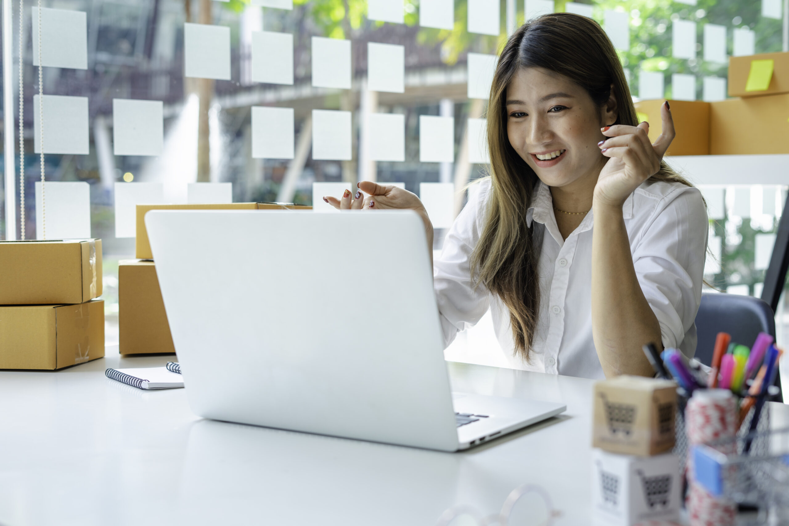 Singapore business owner happily reviewing her ecommerce website design